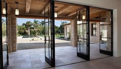 an empty room with glass doors leading to the outside