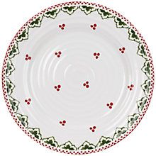 a white plate with red berries and green leaves on the rim, against a white background