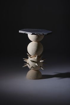 a stack of rocks sitting on top of each other in front of a black background