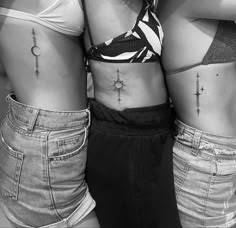 two women with cross tattoos on their stomachs