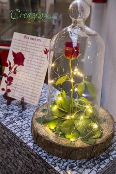 an image of a glass bell jar with flowers in it on top of a table