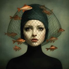 a woman with fish on her head and netted veil over it's head