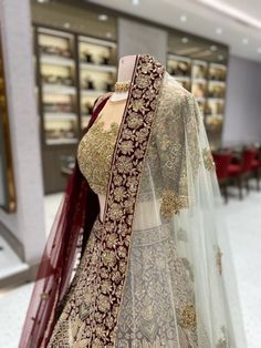 Indulge in luxury with our Burgundy with Gold Bridal Lehenga BL-144. The rich burgundy velvet contrasts beautifully with the intricate illusion blouse with gold work, while the sage green accents add a touch of freshness. Complete your look with our two stunning dupattas in matching burgundy and sage green. Fabric: Velvet! WASH CARE INSTRUCTIONS - Please Dry clean only when it is applicable! Ready to Ship! Elegant Designer Lehenga With Gold Embroidery, Elegant Semi-stitched Choli With Gold Embroidery, Elegant Choli With Gold Embroidery For Reception, Luxury Festive Lehenga With Resham Embroidery, Luxury Lehenga With Intricate Embroidery For Reception, Luxury Lehenga With Dupatta For Reception, Elegant Gold Embroidered Choli For Wedding, Elegant Gold Velvet Traditional Wear, Elegant Wedding Choli With Gold Embroidery