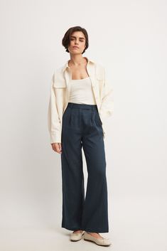 These pants feature a high waist with a zipper and button closure and belt loops. They have two side slanting pockets at the front and two back mock pockets. The pants have wide legs. Inseam length in size 36: 79 cm / 31.1 in. Chic Wide-leg Work Pants With Pockets, Wide-leg Work Pants With Patch Pockets, Fall Wide Leg Work Pants With Welt Pockets, Relaxed Fit Wide Leg Cargo Pants With Button Closure, Wide Leg Work Pants With Patch Pockets, Fall Wide Leg Pants With Patch Pockets, High-waisted Wide Leg Pants With Patch Pockets, Relaxed Fit Wide Leg Pants With Welt Pockets, Wide-leg Cargo Pants For Work