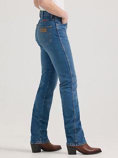 Our 14MWZ has always been a favorite for a reason. This latest rendition with premium denim washes doubles down on the sorcery, with a vintage-inspired fit featuring a super high-rise silhouette that sits at your natural waist, a slim fit through the thigh, and a tapered leg that fits perfectly over cowgirl boots. It’s crafted from premium cotton with just a hint of stretch to keep you comfortable no matter what the day throws your way. These bootcut jeans for women also come with all the iconic Wrangler Straight Leg Jeans, Wrangler Bootcut Jeans Women, Wrangler Texas Jeans, Colorful Wrangler Jeans, Bootcut Jeans For Women, Women’s Wrangler Jeans, Denim Washes, Boot Cut Jeans, Jeans For Women