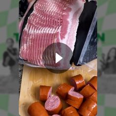 someone is cutting up raw meat on a wooden board