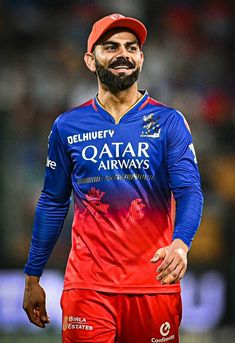 a man with a beard wearing a blue and red uniform