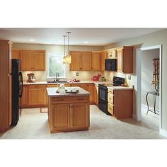 a kitchen with wooden cabinets and black appliances