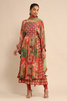 Orange floral print anarkali with an embroidered yoke. Paired with a legging and dupatta with tassels. - Aza Fashions