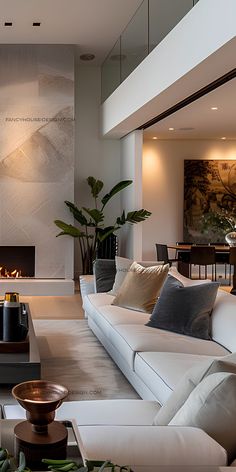 a living room filled with furniture and a fire place next to a wall mounted tv