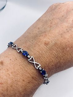 This Blue Iolite and white sapphire bracelet is very lively and bright.  The stones are deep colors and well matched.  The sterling silver is plated with rhodium to protect the bracelet from tarnish and give the appearance of white gold. 7.5 inches Our jeweler can shorten this for a $20 fee.  All jewelry is shipped in a nice gift box.   Check out our over a THOUSAND great reviews Engraving is $4 per letter and is not always perfect depending on the piece. It can take a few days if the jeweler is Blue Sapphire Bracelets For Anniversary, Blue Sterling Silver Tennis Bracelet For Anniversary, Blue Sterling Silver Bracelet For Anniversary, Blue Sterling Silver Bracelets For Anniversary, Sapphire Sterling Silver Bracelet, Sapphire Bracelets With Diamond Accents For Anniversary, Anniversary Bracelets With Sapphire And Diamond Accents, Blue Bracelets With Diamond Accents For Gift, Silver Sapphire Bracelets For Anniversary