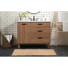 a bathroom vanity with two drawers and a mirror on the wall next to a stool