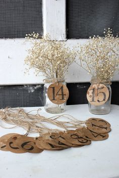 two vases filled with flowers sitting on top of a table