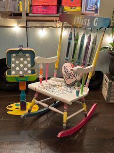 a child's rocking chair that has toothbrushes on it and the word miss g written in large letters