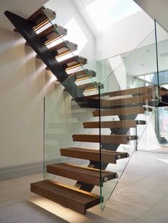 a staircase with glass railing and wooden steps