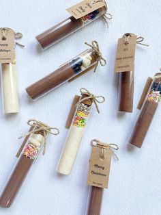 several different types of candles are wrapped in brown paper