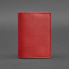 a red leather wallet sitting on top of a table