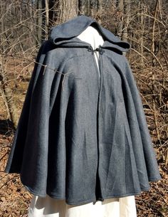 This short cloak is delightfully soft and comfortable. It's long enough to reach the back of the hand, keeping you warm but keeping your hands available when needed. It has a full hood and closes with a matching cloth frog clasp. This cloak is great for a costume piece or a cozy jacket, great for Spring, Fall, or over air conditioned buildings.Your cloak will measure about 30 inches in length. This listing is in dark grey, but other colors are available in my store or on request. The material is One Size Cape For Cold Weather, One Size Outdoor Cape Outerwear, One Size Cape For Outdoor, One Size Outdoor Cape, Hooded Wool Cape For Winter, Solid Hooded Cape For Fall, Medieval Style Fall Cape Outerwear, Medieval Style Fall Cape, Hooded Fall Cape For Larp