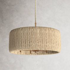 the light fixture is made from rope and has a round shape, with a metal ring at the bottom