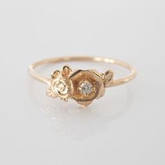 This mini rose flower ring is a beautiful little stacking ring that is like a little bouquet of gold roses and diamonds sitting on your finger. This ring is made in solid 14 karat gold with and set with a genuine VS-SI white diamond.Roses have long since represented love and romance, but are mainly known to represent God's love at work in the world. I made this ring as a reminder to us to always see the beauty and joy in the world.The simplicity of this ring stacks nicely with other rings and je Dainty Rose Gold Cluster Ring For Anniversary, Delicate Rose Gold Flower Ring, Delicate Rose Gold Flower Ring For Promise, Delicate Rose Gold Flower Promise Ring, Dainty Cluster Promise Ring, Delicate Rose Gold Diamond Promise Ring, Fine Jewelry Flower Ring With Rose Design For Promise, Fine Jewelry Rose Design Flower Ring For Promise, Rose Design Flower Ring For Promise