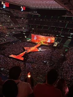 an aerial view of a concert with people in the audience and on stage lighting up