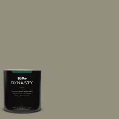 a can of paint sitting on top of a white floor next to a black wall