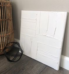 a white paneled wall next to a wicker basket on the floor in a room