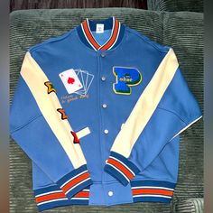 Brand New Varsity Jacket Size: Men’s Large No Brand Name Casual Blue Varsity Jacket For College, Blue Varsity Jacket With Baseball Collar For Streetwear, Casual Blue Hooded Varsity Jacket, Blue Varsity Jacket With Baseball Collar, Blue Urban Varsity Jacket With Baseball Collar, Blue Varsity Jacket For Spring Streetwear, Blue Urban Varsity Jacket For Fall, Urban Style Blue Varsity Jacket For Fall, Urban Blue Long Sleeve Outerwear