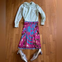 This is a beautiful 1960s Emilio Pucci stretch silk skirt.  It is pleated at the front and zips at the side. It has all of the iconic hallmarks of a vintage pucci skirt - vibrant colors - bright pinks, blues, whites.  It's banded at the waist and bottom, and has flowers throughout. It's also signed with Emilios signature throughout.  It's marked a vintage size 6 with measurements in photos - approximately an extra small. Overall in good vintage condition with a few small flaws - a few pinholes, Vintage Pucci, Pucci Vintage, Hostess Dresses, 60s Vintage, Vintage Fits, Vintage Plaid, Silver Dress, Silk Skirt, Emilio Pucci