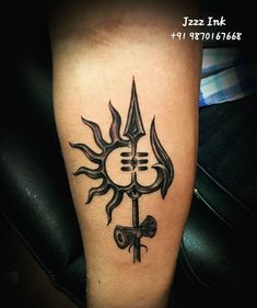 a tattoo on the leg of a person with a cross and sun in the middle