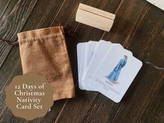 four cards and a bag on a table with the words 12 days of christmas nativity card set