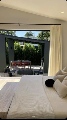 a bedroom with an open patio and sliding glass doors