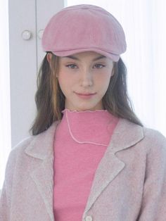 a young woman wearing a pink hat and jacket