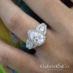 a woman's engagement ring with two pear shaped diamonds on the middle and bottom