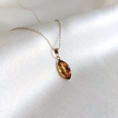 This stunning pendant is set in 14K Solid Yellow Gold with Natural Citrine with utmost precision. It is an unique gemstone pendant for nearly every occasion and is completely hassle-free jewelry. ITEM DETAILS * Gem: Citrine * Gem Size: 7X14mm * Gem Shape: Marquise * Gem Weight: 2.82 carats * Gold Purity: 14KT  * Gold Weight: 0.47 gram * Total Weight of the Pendant: 1.03 gram The Gold purity is guaranteed and it comes with authentic 14KT gold hallmark. Since my items are handmade, they are absolutely nickel and lead free. CUSTOMIZATION * Gemstone customization is available and it can be substituted with a gem of your choice. Kindly message me for the same. PACKAGING * The Pendant comes with layers of safe and secure wrapping along with Free handmade jewelry box with every purchase. ➡️Head t Orange Pendant Necklace, Sunny Disposition, Yellow Hues, Handmade Jewelry Box, Golden Rutilated Quartz, Citrine Jewelry, Citrine Pendant, Personalized Pendant, Bezel Pendant