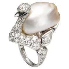 A BUNDA 'Swan' ring in platinum, featuring an exquisite, baroque Cultured South Sea Keshi Pearl, champagne in colour with a clean skin and an excellent lustre. The Swan itself features a round brilliant cut diamond pave set body with bezel set pear and marquise diamonds. Dimensions of pearl: 15.80-21.80mm Characteristics of pear shaped diamonds: 2 = 1.13ct, D-F colour, SI1 clarity. Characteristics of marquise diamonds: 2 = 0.49ct, F colour, VS clarity. Characteristics of round brilliant cut diam Van Cleef And Arpels Jewelry, Van Cleef And Arpels, Pearl And Diamond Ring, Kesha, Yoko London, Bridal Ring Sets, Color Champagne, Diamond Engagement Ring Set, Sea Pearl