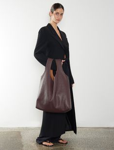 The Reversible Suede / Leather Sack is crafted from two single pieces of material, offering a minimalist design that mixes materials and texture to enforce a new take on modern craftsmanship. This hobo-style shoulder bag features a soft, unstructured form and no hardware, easily converting between natural suede and burgundy grain leather. Its oversized silhouette provides ample space and softens with use, making it ideal as a large day bag and travel bag. Carry over the shoulder, on the arm, or Everyday Structured Shoulder Bag With Smooth Grain, Chic Reversible Shoulder Bag For Everyday, Versatile Business Hobo Tote Bag, Textured Leather Hobo Shoulder Bag For Work, Brown Smooth Grain Hobo Bag For Work, Structured Hobo Bag For Everyday Use, Textured Leather Shoulder Bucket Bag For Work, Smooth Grain Hobo Bag Tote For Work, Smooth Grain Hobo Bag In Tote Shape For Work