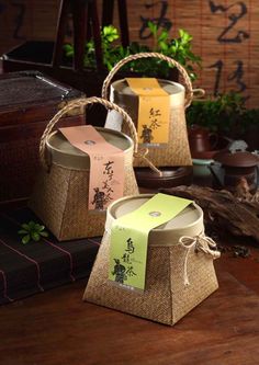 three baskets with tags on them sitting on a table