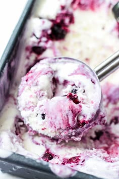 a scoop of blueberry cheesecake ice cream in a metal pan with a spoon