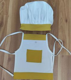 the apron is made out of white and yellow material, with a square in the center