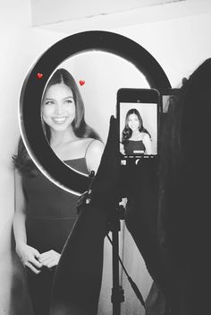 a woman taking a selfie in front of a mirror