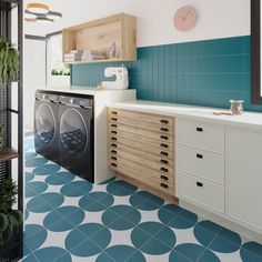 a washer and dryer sitting in a room next to each other with blue tiles on the floor