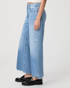 This high-rise wide leg comes in a light vintage-inspired wash with natural fading, lived-in details, and a destructed hem. This pair is crafted from our PAIGE VINTAGE denim which takes all of the work out of breaking in your favorite pair of vintage jeans. We've combined the comfort of stretch with everything you love about rigid vintage denim to create super soft jeans that feel perfectly lived-in from the very first wear. | Zoey 31 Inch Wide Leg Jean - Rumors Blue | Size 32 Mid-rise Wide Leg Denim Pants With Frayed Hem, Mid-rise Denim Wide Leg Pants With Frayed Hem, Faded Wide Leg Cropped Jeans For Spring, Wide Leg Cropped Jeans For Spring, Distressed Wide Leg Cropped Jeans In Light Wash, Light Wash Distressed Wide Leg Cropped Jeans, Distressed Wide Leg Relaxed Fit Flare Jeans, Distressed Wide Leg Flare Jeans With Relaxed Fit, Wide Leg Distressed Light Wash Cropped Jeans