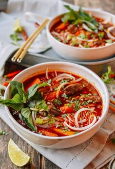 two bowls of soup with meat and vegetables