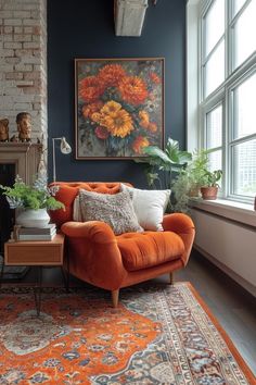 an orange couch sitting in front of a window next to a rug and potted plants