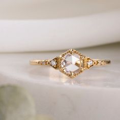 a diamond ring sitting on top of a table