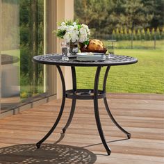 a table that has some food on it and flowers in vases next to it