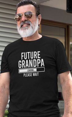 a man wearing a papa est t - shirt standing in front of a house with sunglasses on