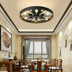 a dining room table and chairs in front of a window