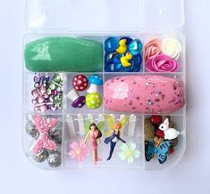 a plastic container filled with lots of different types of toy figurines and accessories